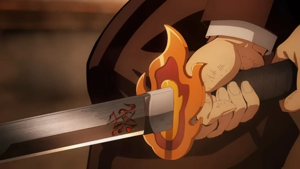 Empuñadura de la espada de Rengoku, en las manos de Tanjiro